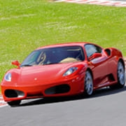 red ferrari on a racetrack